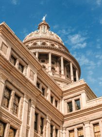 A low angle shot of Texas Capitol building under a blue beautiful sky. Austin city, Texas